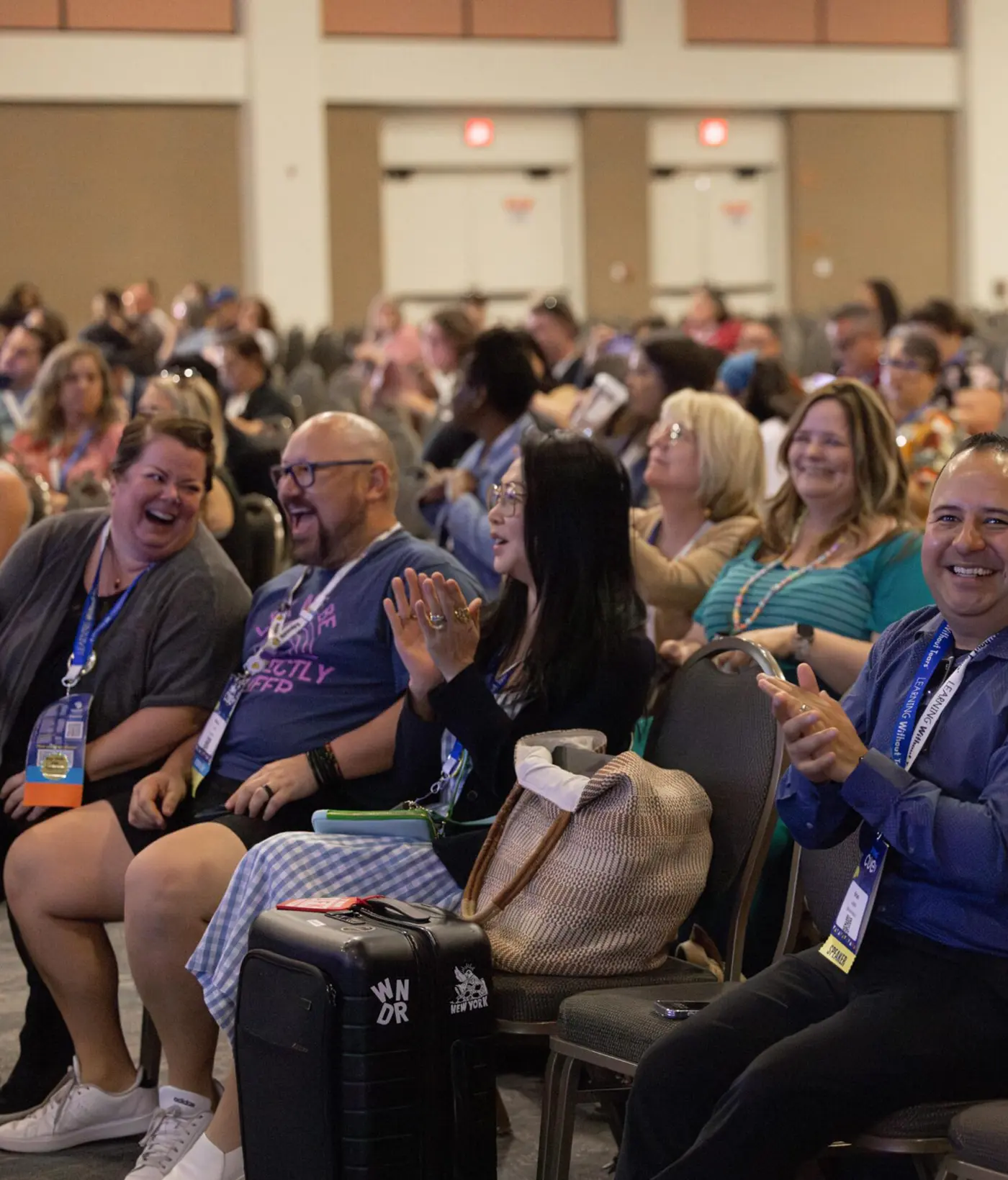 Audience of educators laughing and applauding during a keynote presentation at the Spring CUE Conference 