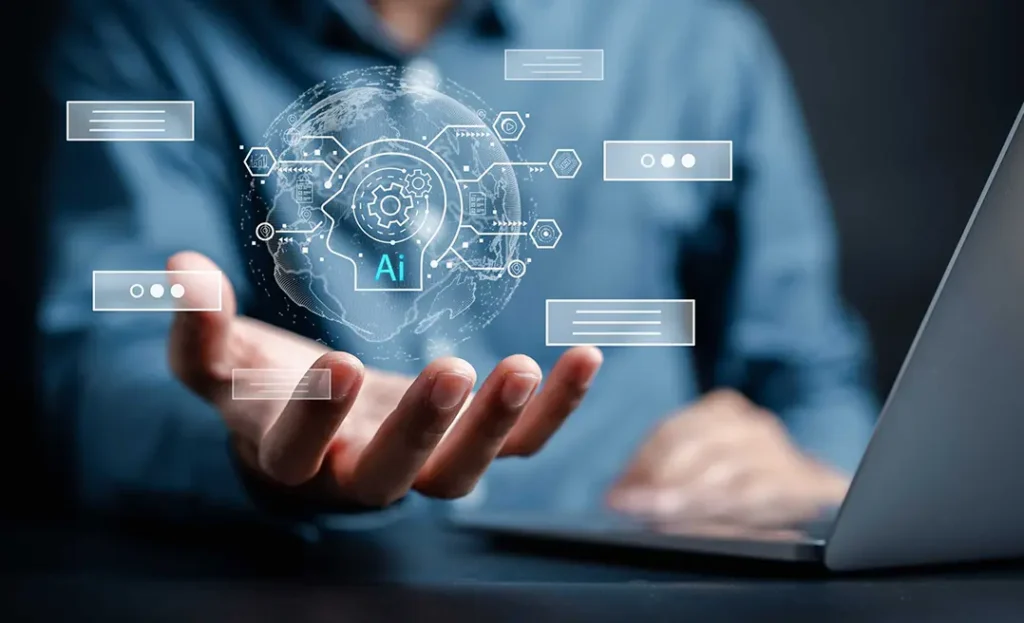Person using laptop with a digital hologram of artificial intelligence technology hovering above their hand.